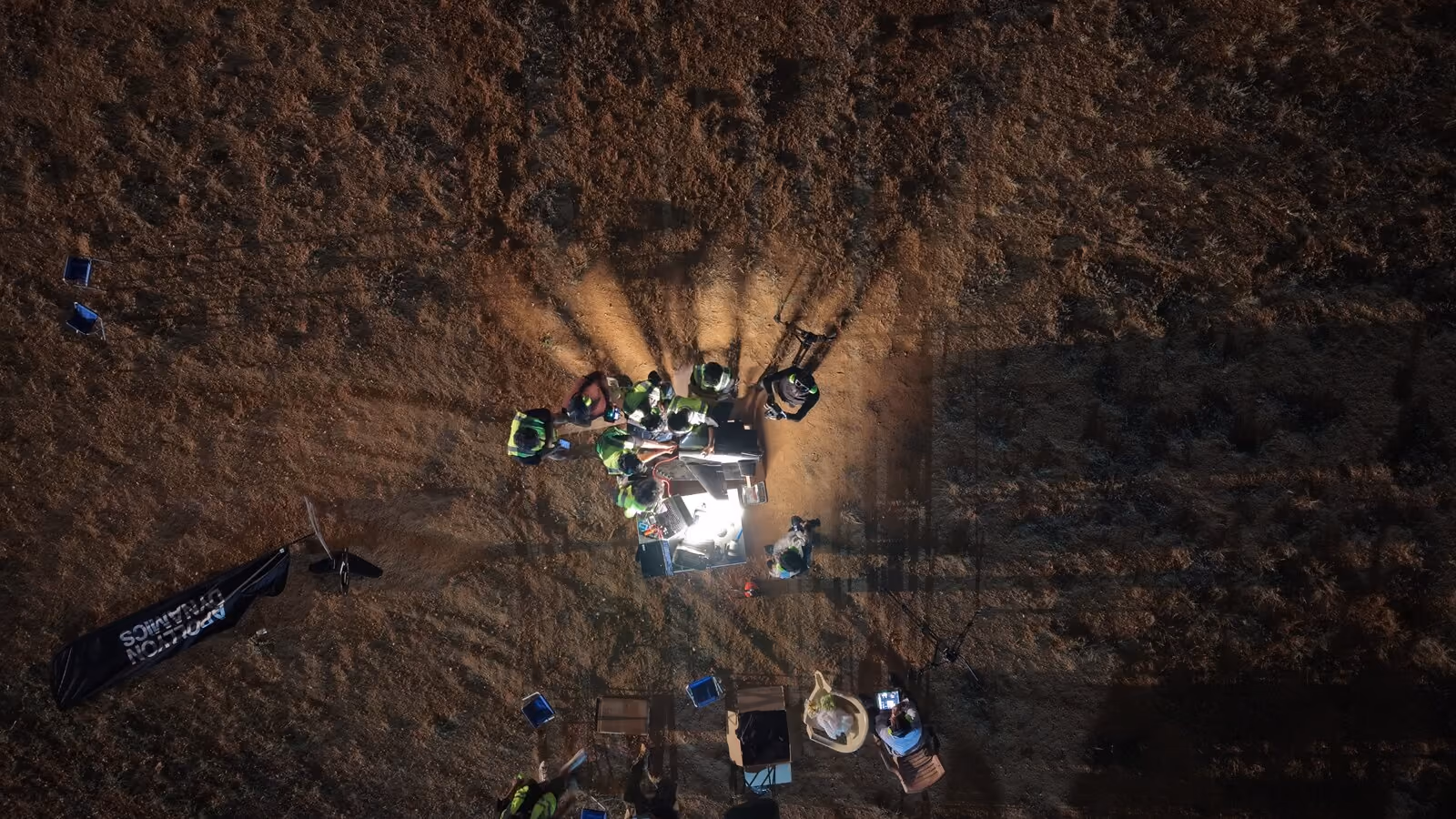 The Apollyon Dynamics team preparing a drone at night